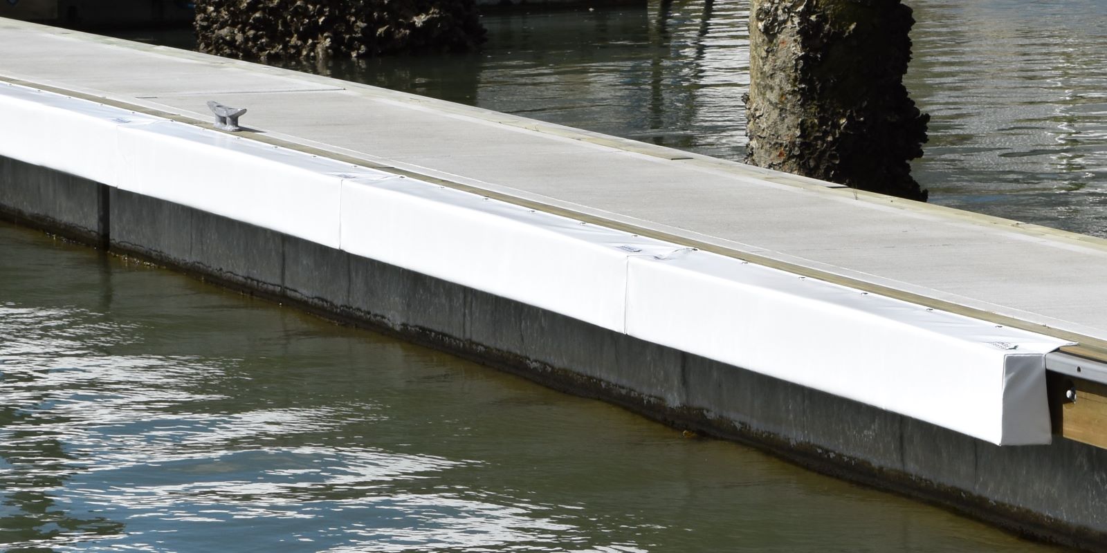 Contoured Barrier Fenders available from Hauraki Fenders - 2m pvc covered foam marina fender shaped to fit around a marina berth rub strip
